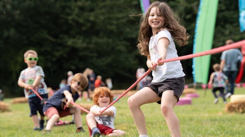 Children taking part in Tug of War during Summer of Play at Fountains Abbey, Yorkshire